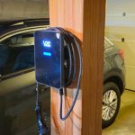 Borne de recharge installée sur un poteau dans un parking collectif de copropriété par United Borne